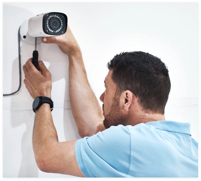 Technician installing a security camera
